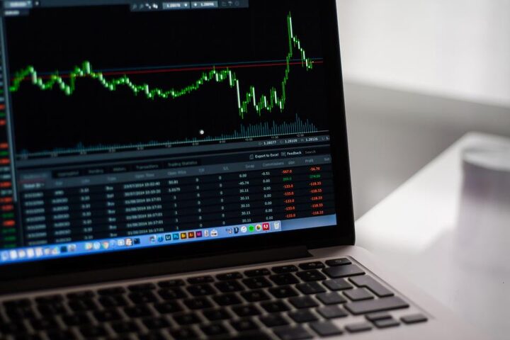 A candlestick price chart open on a laptop